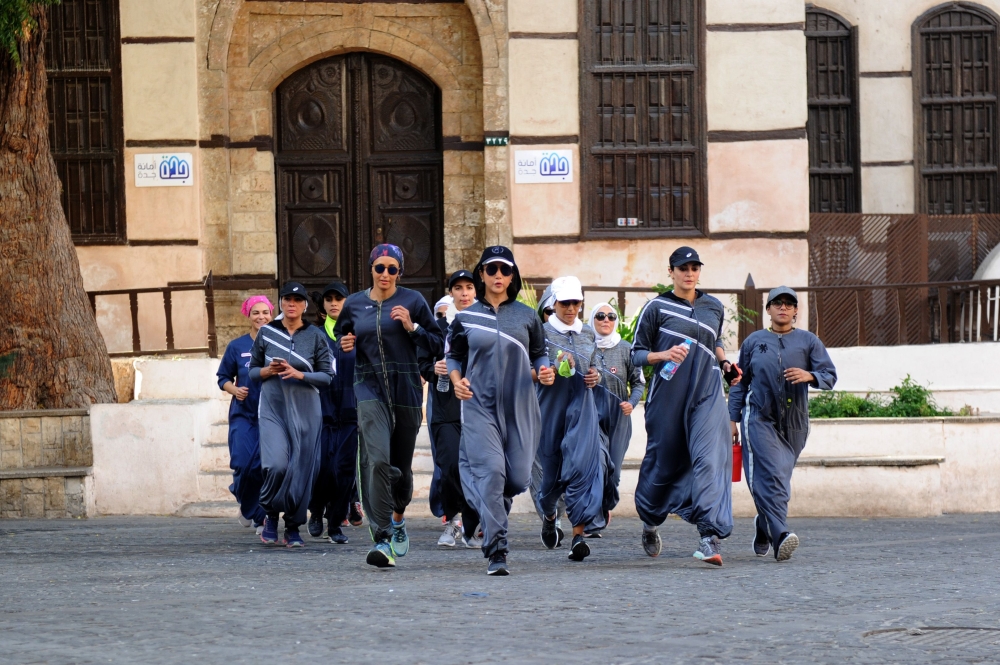 Saudi women jog in the streets of Jeddah's historic Al-Balad district on March 8, 2018, in colorful and sports-friendly version of the abaya gowns. — AFP
