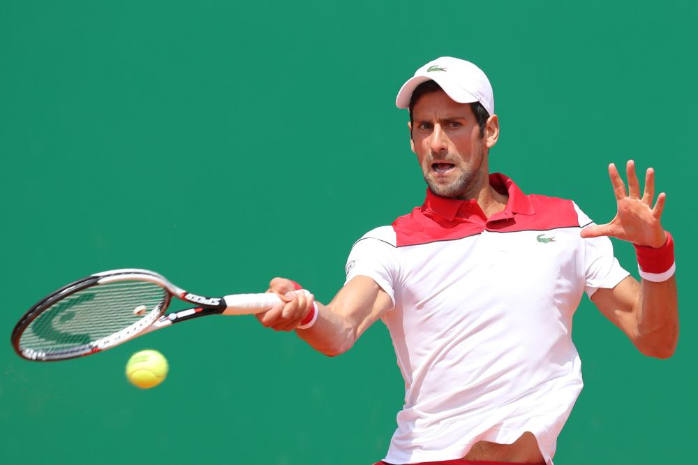 Serbia's Novak Djokovic returns the ball to Croatia's Borna Coric during their match at the Monte-Carlo ATP Masters Series Tournament in Monaco Wednesday. — AFP