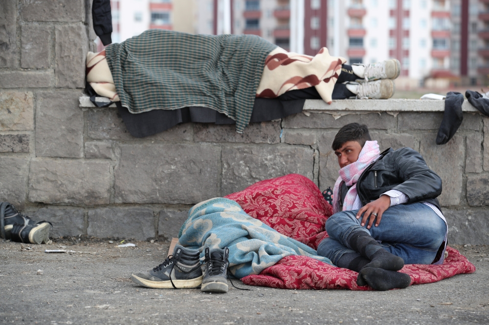 Afghan migrants rest outside a bus terminal as they struggle to find buses to take them to western Turkish cities after crossing the Turkey-Iran border in Agri, earlier this month. 