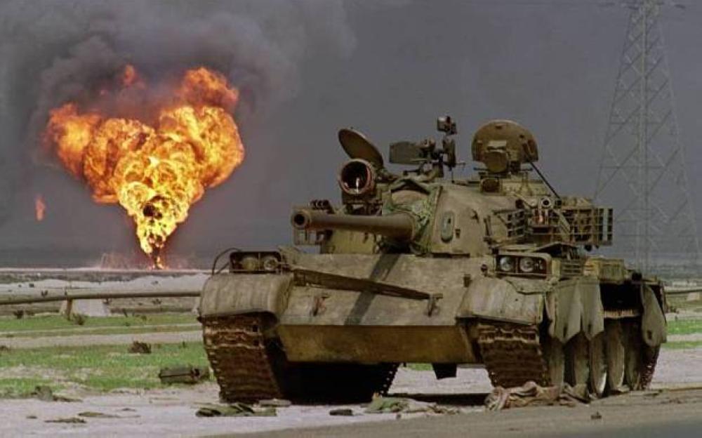 An Iraqi tank sits abandoned in an oilfield in Kuwait. In the background an oil well has been set alight by retreating Iraqi forces. — File photo
