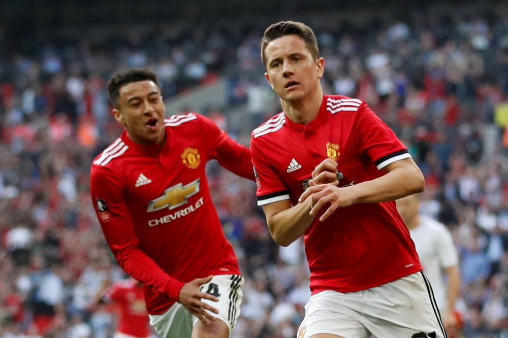 Manchester United's Ander Herrera (R) celebrates scoring their second goal against Tottenham Hotspur with Jesse Lingard during their FA Cup semifinal at the Wembley Stadium, London, Saturday. — Reuters