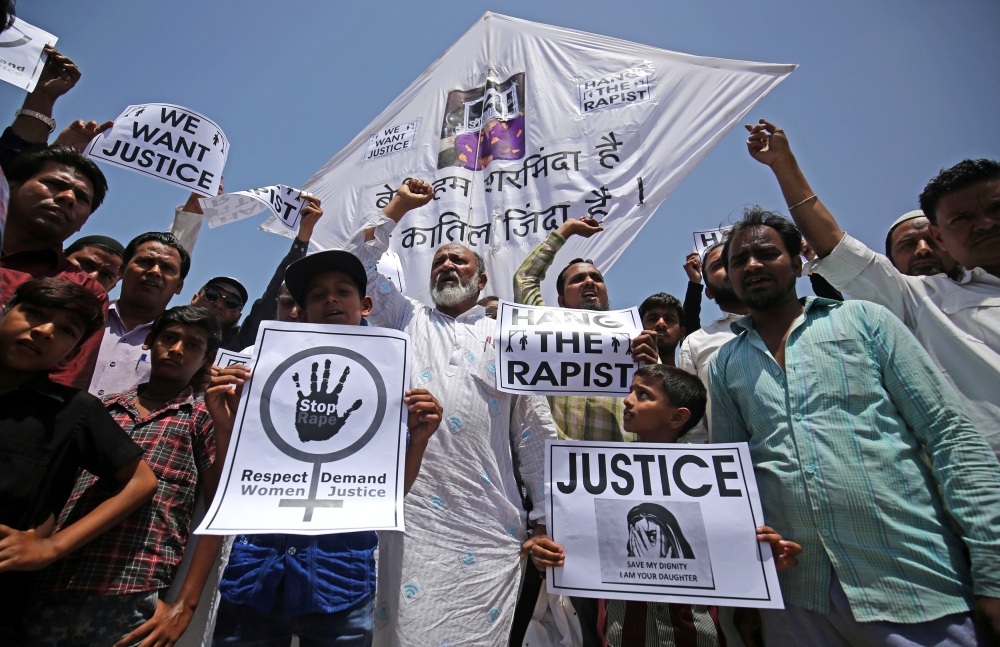People hold placards at a protest against the rape of an eight-year-old girl, in Kathua, near Jammu, a teenager in Unnao, Uttar Pradesh state, and an eleven-year-old girl in Surat, in Ahmedabad, India, on Sunday. — Reuters
