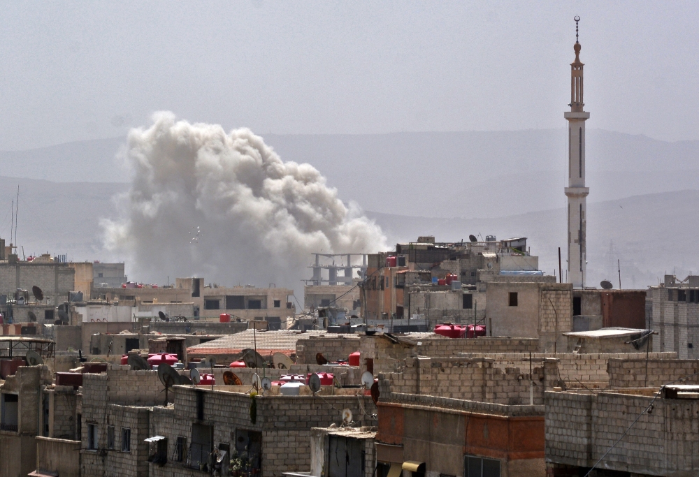 Smoke billows in a southern district of the Syrian capital Damascus during regime strikes on the Palestinian camp of Yarmuk and neighboring districts. — AFP