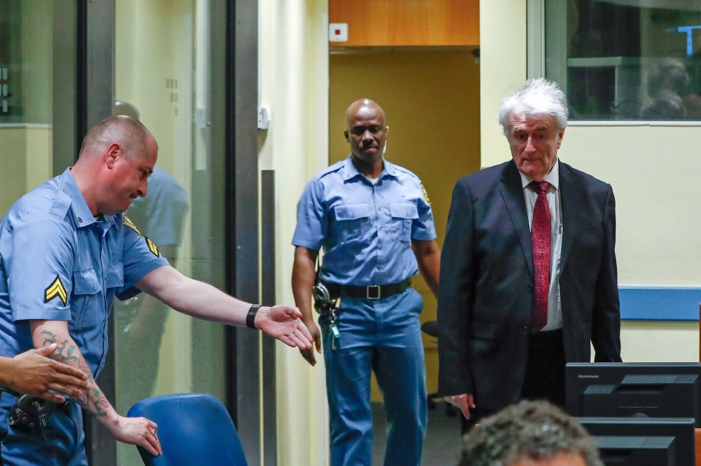 Former Bosnian Serb leader Radovan Karadzic appears in a courtroom before the International Residual Mechanism for Criminal Tribunals (MICT), which is handling outstanding war crimes cases for the Balkans and Rwanda, in The Hague, Netherlands, on Monday. — EPA