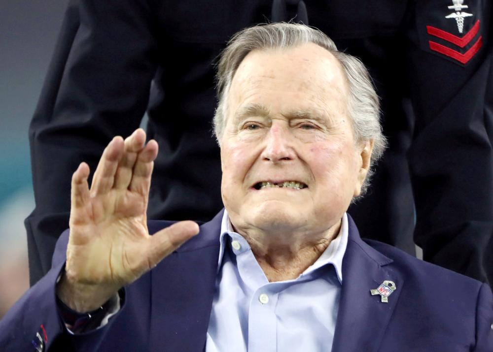 Former U.S. President George H.W. Bush arrives on the field to do the coin toss ahead of the start of Super Bowl LI between the New England Patriots and the Atlanta Falcons in Houston, Texas, in this Feb. 5, 2017 file photo. — Reuters