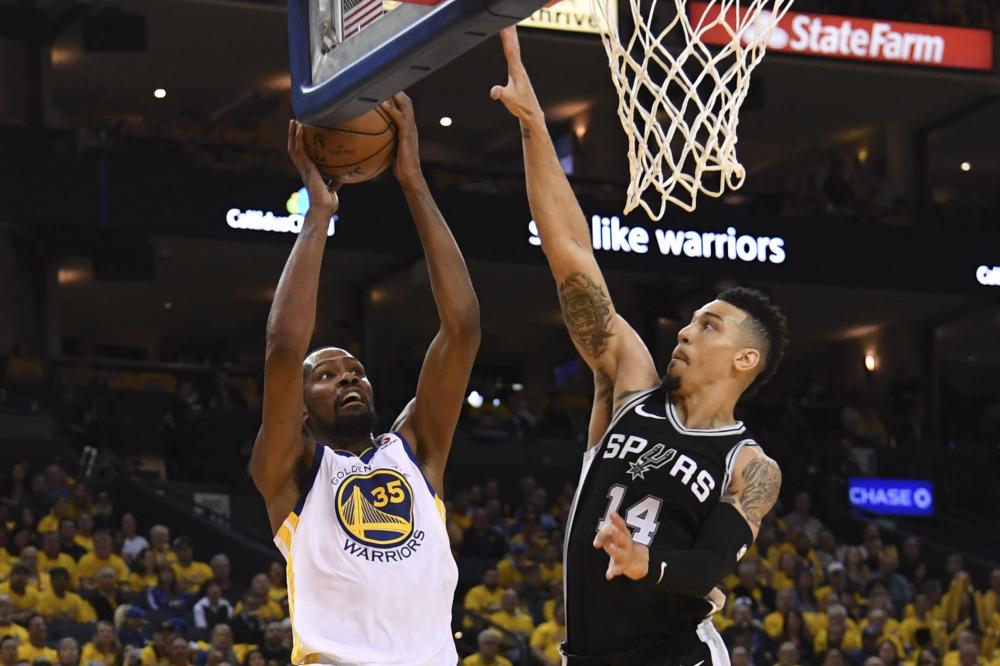 Golden State Warriors’ forward Kevin Durant shoots against San Antonio Spurs’ guard Danny Green during Game 5 of the first round of the 2018 NBA playoffs at Oracle Arena in Oakland Tuesday. — Reuters