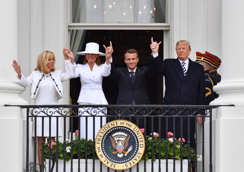 US President Donald Trump (R), French President Emmanuel Macron (2nd R), US First Lady Melania Trump (2nd L) and French First Lady Brigitte Macron are seen on the balcony  at the White House in Washington, DC. — AFP