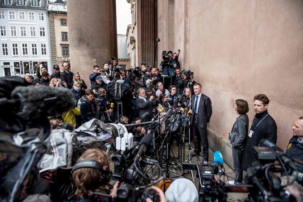 Prosecutor Jakob Buch-Jepsen, center, speaks with journalists at a press briefing in front of the courthouse in Copenhagen after the verdict in the case of Peter Madsen was announced in Copenhagen, Denmark, on Wednesday. — AFP