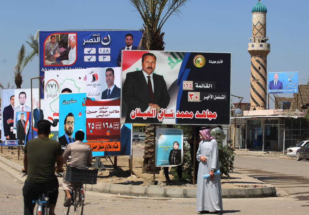 Iraqis ride their bikes past posters of candidates for legislative elections in Ramadi, Anbar province, western Iraq. In the vast desert province of Anbar where Daesh (the so-called IS) militants first emerged in Iraq, parliamentary elections next month are an opportunity for the predominantly Sunni residents to settle scores. — AFP
