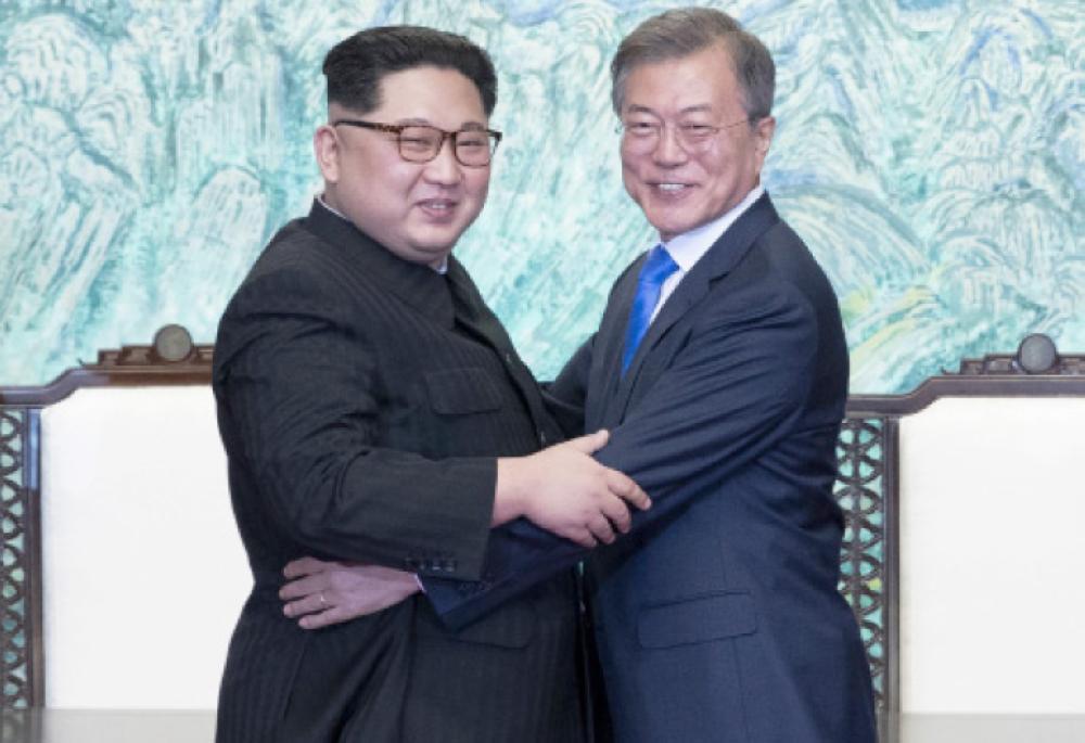 North Korean leader Kim Jong-Un (left) hugs South Korean President Moon Jae-In after signing a document at the Joint Security Area (JSA) on the Demilitarized Zone (DMZ) in the border village of Panmunjom in Paju, South Korea, Friday. — EPA