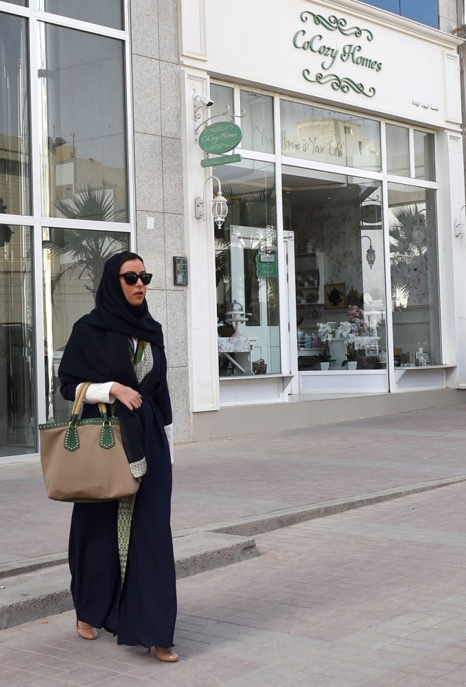 President of the Arab Fashion Council in Saudi Arabia Princess Noura Bint Faisal (left) greets a member of her team in the Al-Faisaliyah mall in the Saudi capital Riyadh, last week. The princess inspired by her time living in Tokyo is the new face of fashion in the Kingdom, where dramatic reforms have sparked equal parts optimism and skepticism. — AFP photos