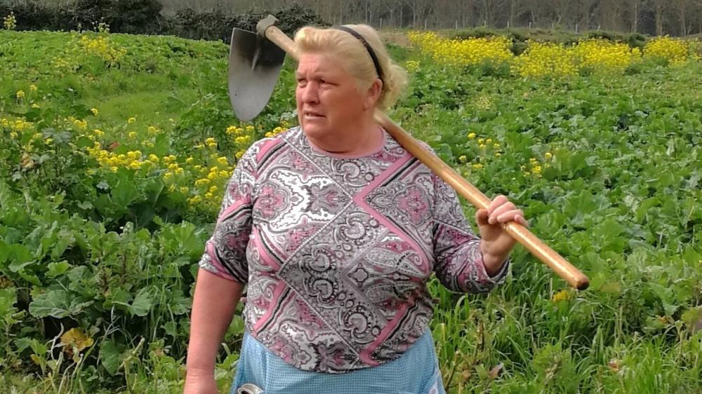 Dolores Leis stands in a field on her farm in Galicia, in northern Spain. - AP