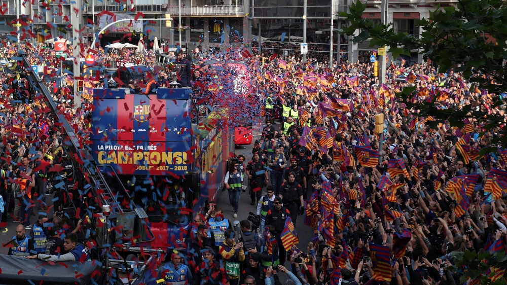 FC Barcelona players and fans celebrate during the parade in Barcelona on Monday. — Reuters