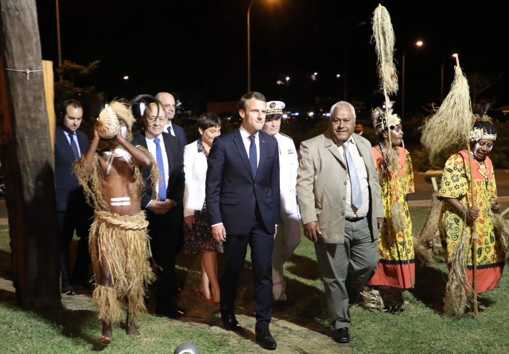 French President Emmanuel Macron (center) walks with President of the 'Senat Coutumier' Pascal Sihaze (center/right) French Foreign Affairs Minister Jean-Yves Le Drian (2nd left), High Commissioner in New Caledonia Thierry Lataste (rear) and others as he arrives to attend a welcoming ceremony at The Coutumier Senate in Noumea, Thursday. Macron's plane landed in Noumea, New Caledonia, for the second leg of the president's trip to the Pacific, six months before the referendum on the independence of the island. — AFP