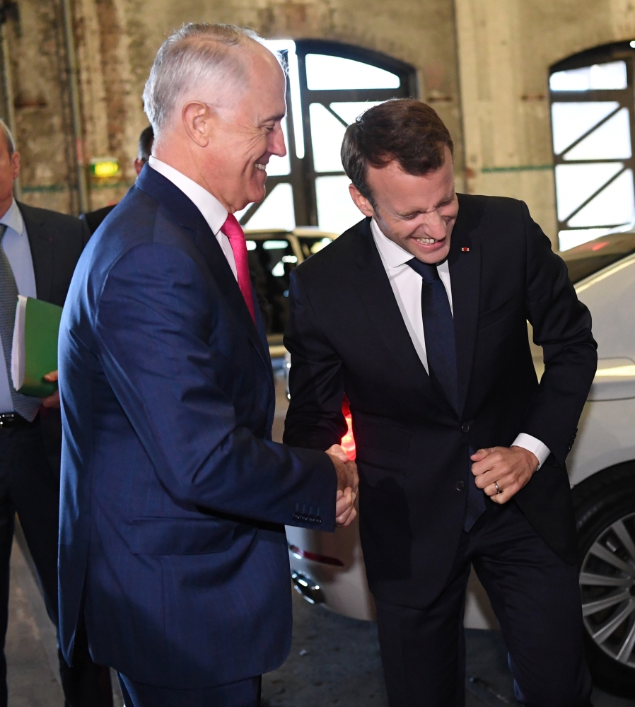 French President Emmanuel Macron (center) walks with President of the 'Senat Coutumier' Pascal Sihaze (center/right) French Foreign Affairs Minister Jean-Yves Le Drian (2nd left), High Commissioner in New Caledonia Thierry Lataste (rear) and others as he arrives to attend a welcoming ceremony at The Coutumier Senate in Noumea, Thursday. Macron's plane landed in Noumea, New Caledonia, for the second leg of the president's trip to the Pacific, six months before the referendum on the independence of the island. — AFP