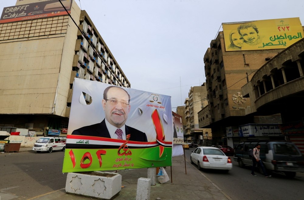 A campaign poster of former Iraqi prime minister Nuri Al-Maliki is seen in the street ahead of the parliamentary election, in Baghdad. — Reuters