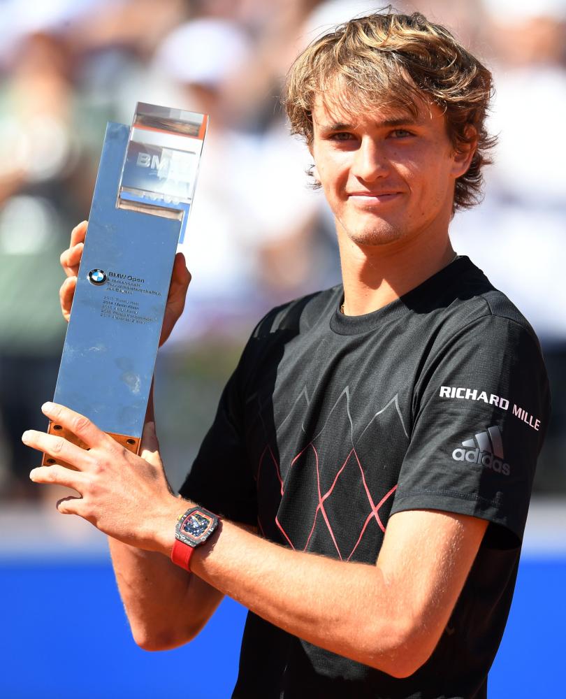 Germany’s Alexander Zverev poses with the trophy after defeating his compatriot Philipp Kohlschreiber in the final at the ATP Open in Munich Sunday. — AFP