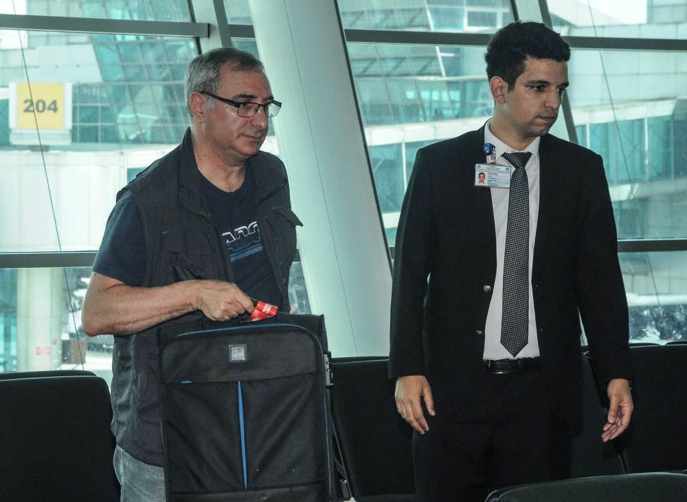 Israeli Ambassador to Turkey Eitan Naeh (L) holds his luggage at Istanbul Ataturk Airport on Wednesday as he prepares to leave Turkey.  — AFP