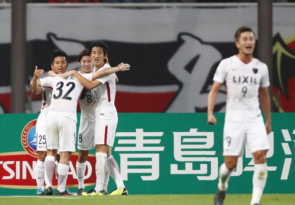 Players of Kashima Antlers of Japan celebrate after scoring during the AFC Champions League round of 16 football match against China's Shinghai SIPG in Shanghai Wednesday. — AFP
