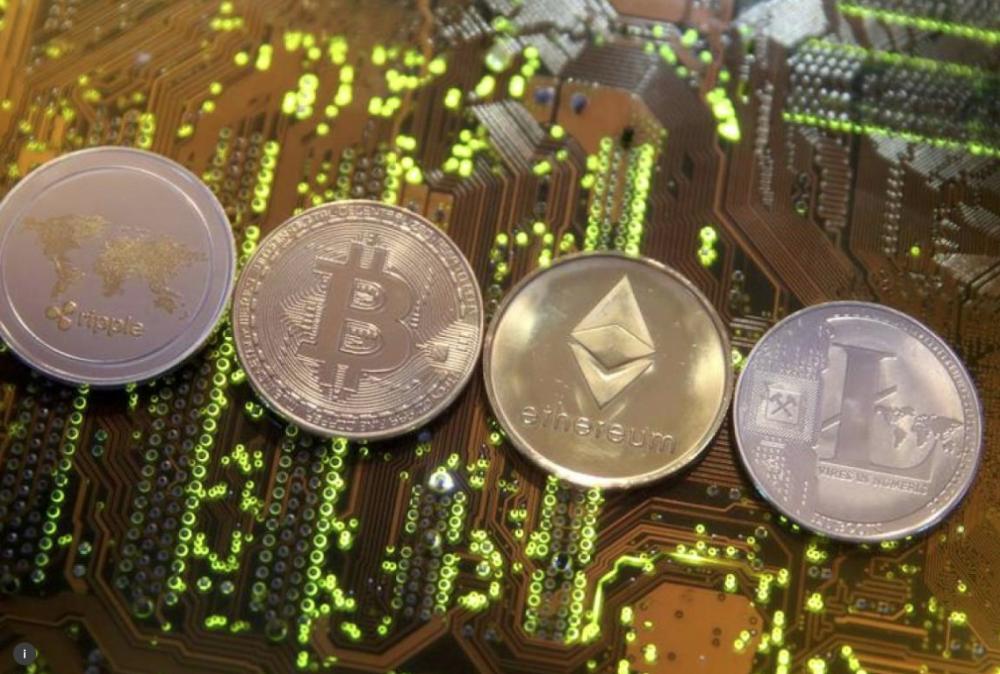 File photo shows representations of the Ripple, Bitcoin, Etherum and Litecoin virtual currencies  on a PC motherboard in this illustration picture. – Reuters