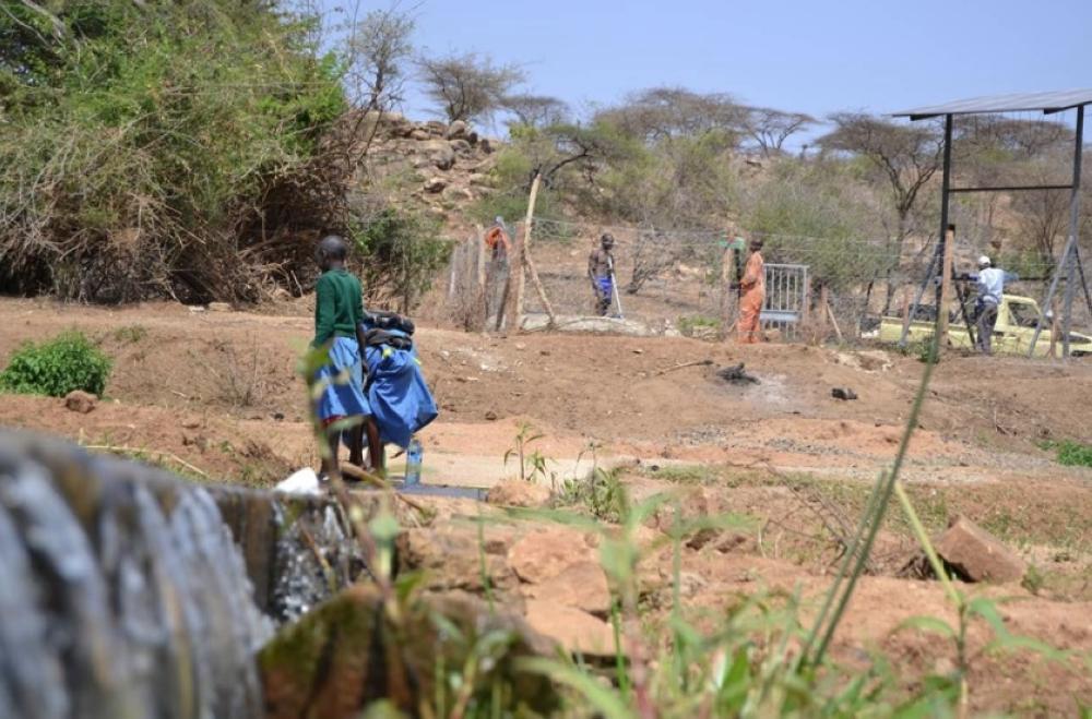 Phyllis Mugeni working at her greens garden along the edges of river Naka in central Kenya. Slow land adjudication is putting pressure on wetlands in rural Kenya. — Thomson Reuters Foundation/