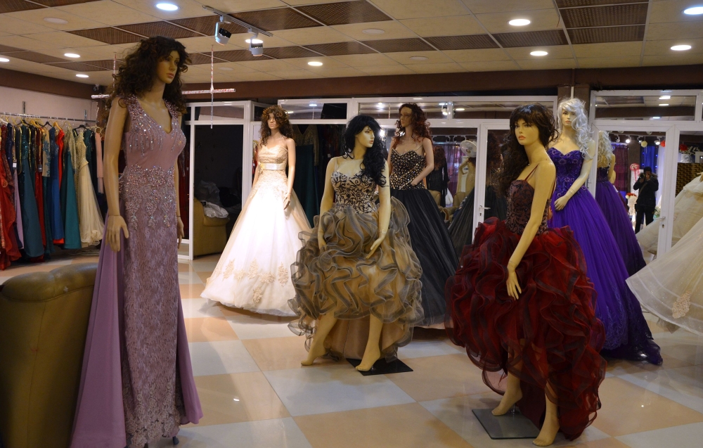 Evening wear and wedding dresses are displayed in a showroom in the northern Iraqi city of Mosul. Before Daesh (the so-called IS) militants made Mosul their self-proclaimed capital in mid-2014, Iraq's second city was a bastion of traditionalism and conservatism. It was rare for women to hit their 20s before marrying or being engaged, but now suitors are finding it increasingly hard to save enough cash to fund a dowry and a wedding, never mind set up home with a spouse. — AFP