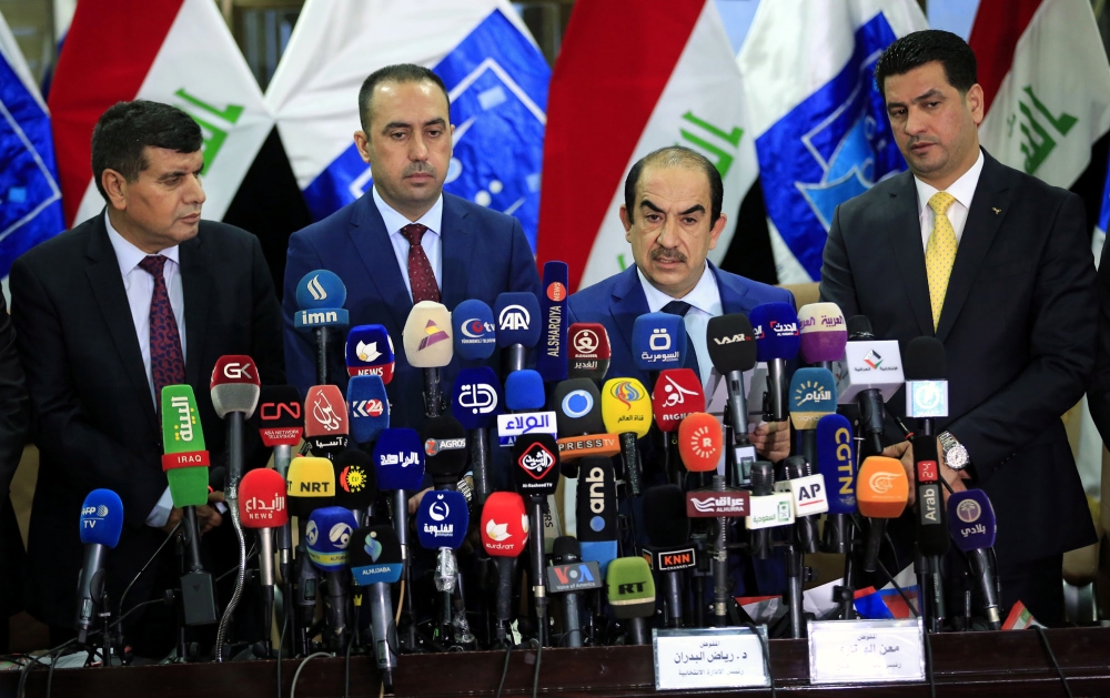 Riyadh Al-Badran (C-R), the head of Iraq's Independent Higher Election Commission, attends a press conference with members of the Commission to announce the official results of parliamentary election in Baghdad on Saturday. — EPA
