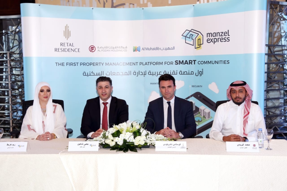 Officials of Al-Fozan & Al-Muhaidib Real Estate Group and ‘Manzel Express’ during the signing ceremony. — Courtesy photo