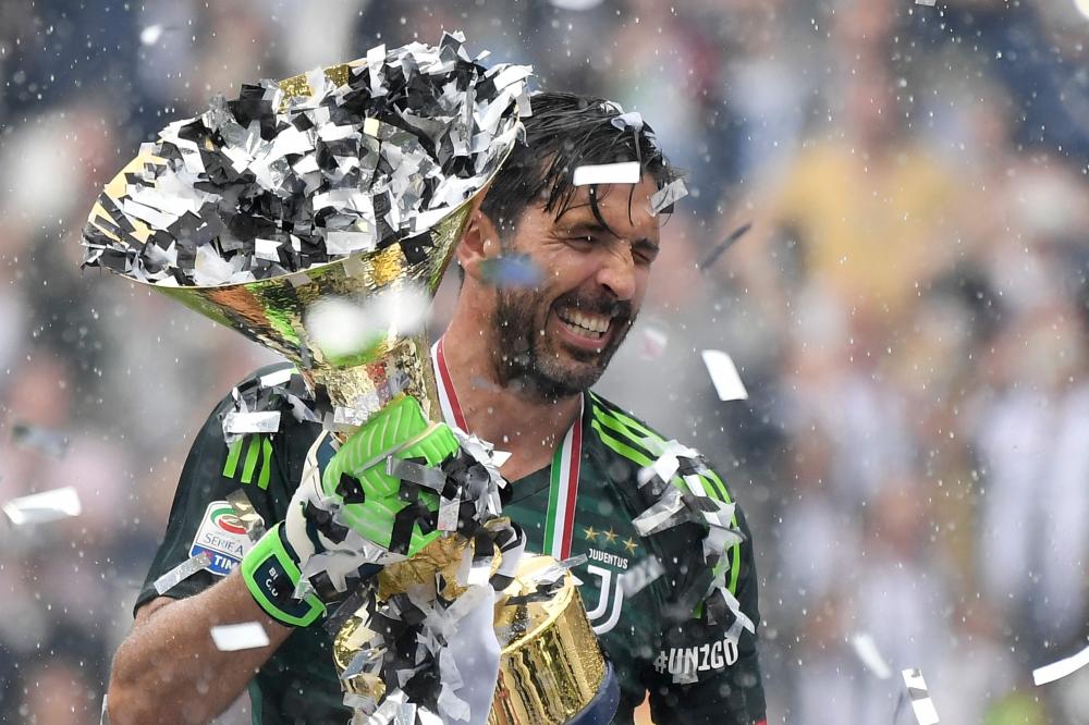 Juventus' goalkeeper from Italy, Gianluigi Buffon, lifts the trophy during the victory ceremony following the Italian Serie A last football match of the season against Verona at the Allianz Stadium in Turin. Juventus won its 34th Serie A title (scudetto) and seventh in succession. — AFP 