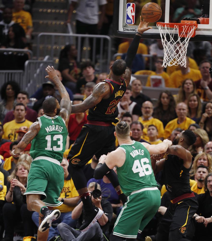 LeBron James of the Cleveland Cavaliers goes to the basket against Marcus Morris (L) and Aron Baynes (2-R) of the Boston Celtics during Game 3 of the Eastern Conference finals at Quicken Loans Arena in Cleveland Saturday. — EPA