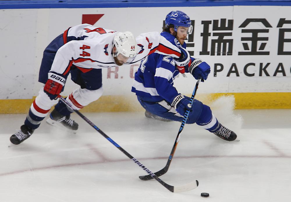 Washington Capitals’ defenseman Brooks Orpik (L) and Tampa Bay Lightning’s center Brayden Point battle for the puck during Game 5 of the Eastern Conference finals in the 2018 Stanley Cup Playoffs at Amalie Arena in Tampa Saturday. — Reuters 
