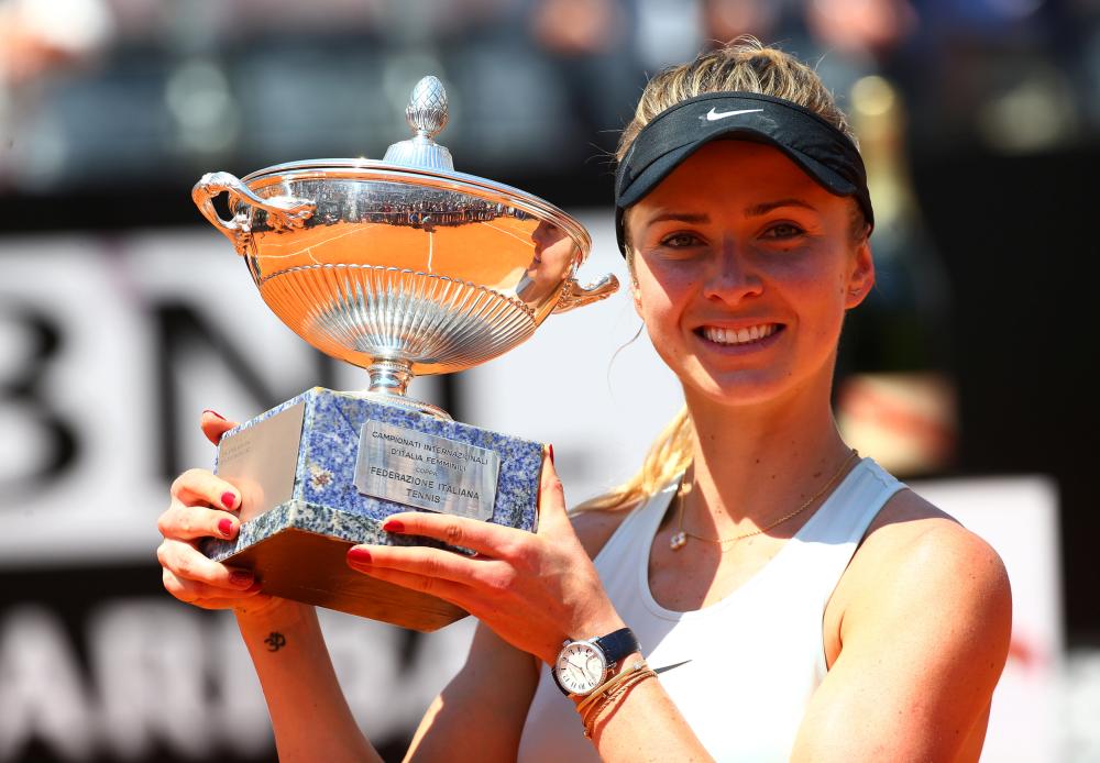 Ukraine’s Elina Svitolina celebrates with the trophy after winning the Italian Open final against Romania’s Simona Halep in Rome Sunday. — Reuters