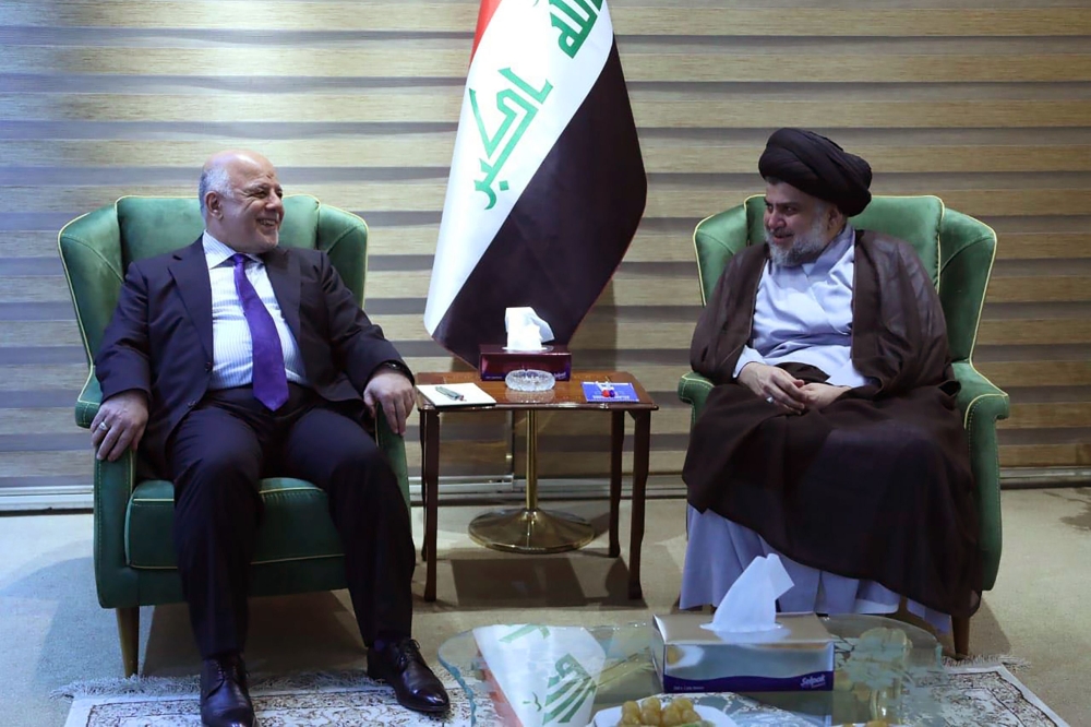 This handout picture released by the Iraqi Prime Minister's press office on Sunday shows Iraqi Prime Minister Haider Al-Abadi meeting with Iraqi Shiite cleric and leader Moqtada Al-Sadr in Baghdad. — AFP