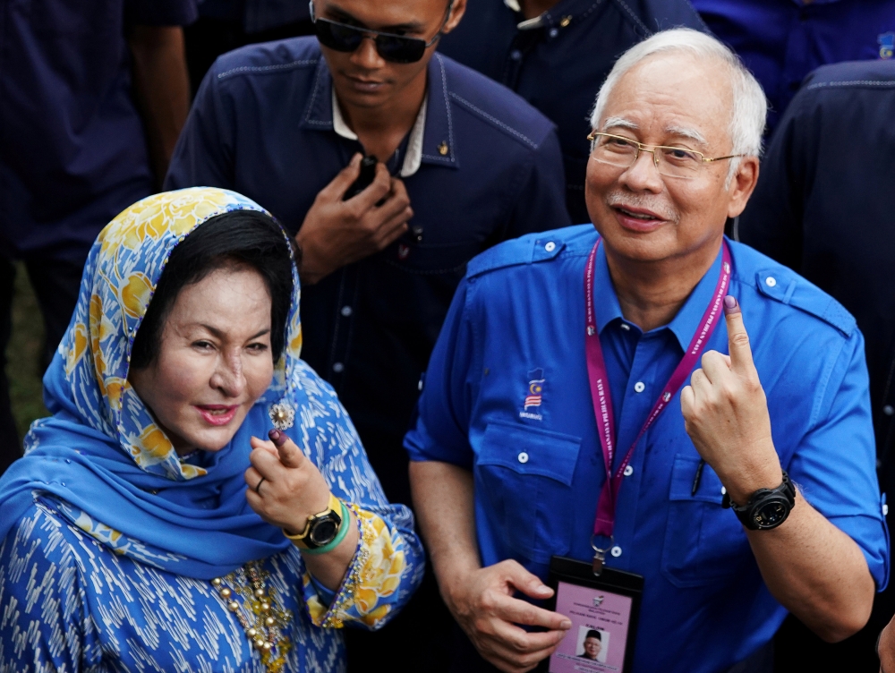 Former Malaysian Prime Minister Najib Razak of Barisan Nasional (National Front) and his wife Rosmah Mansor show their ink-stained fingers after voting in Malaysia’s general election in Pekan, Pahang, Malaysia, in this May 9, 2018 file photo. — Reuters