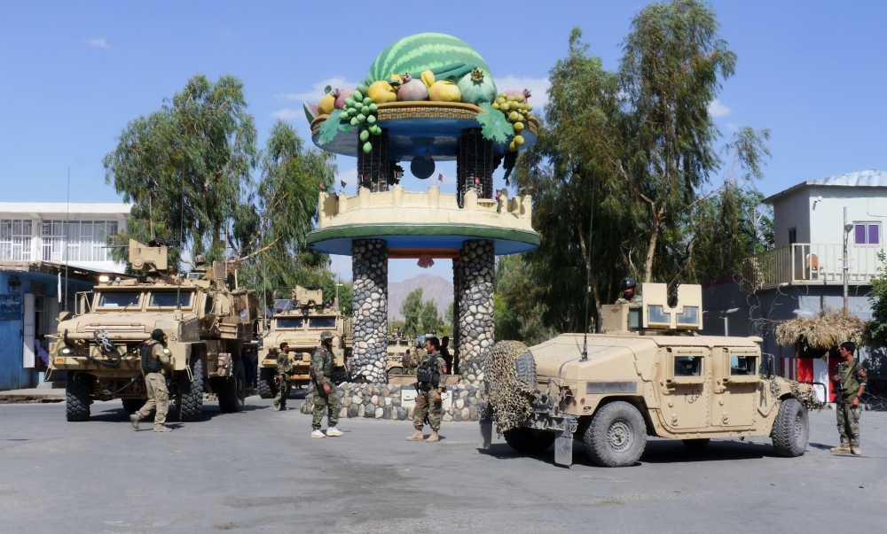 Afghan security forces patrol after recapturing control of the city from Taliban militants in Farah on Sunday. — AFP
