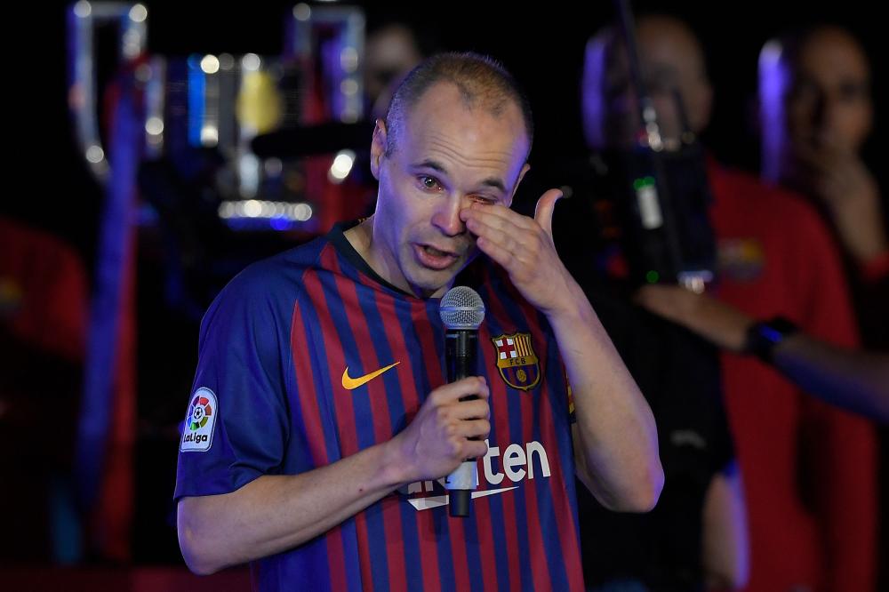 Barcelona’s Andres Iniesta wipes his tears during a tribute after the Spanish league football against Real Sociedad at the Camp Nou Stadium in Barcelona Sunday. — AFP