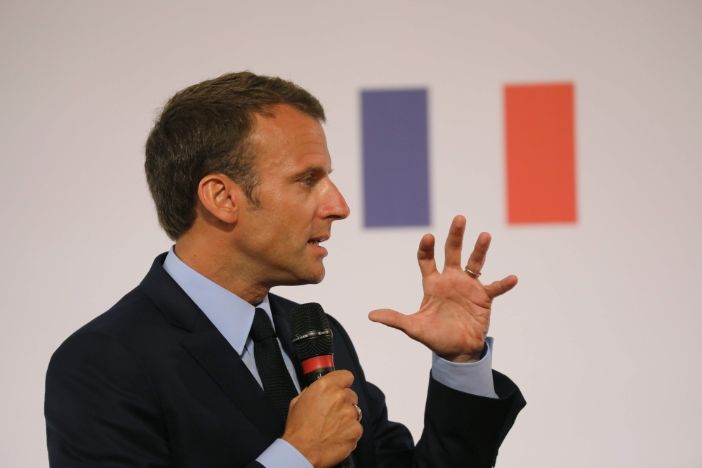 French President Emmanuel Macron gestures as he speaks during the presentation of the French government’s battle plan for the country’s most deprived areas in Paris on Tuesday. — AFP