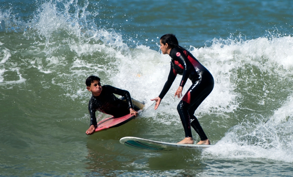 Meriem, a 29-year-old Moroccan engineer and surfer, surfs off the coast of Rabat. — AFP
