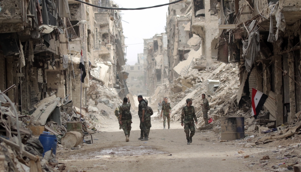 Syrian soldiers patrol at the Yarmouk Camp district in south Damascus, Syria. — EPA