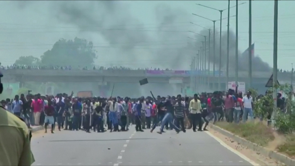 People pelt stones during a protest against the construction of a copper smelter by Vedanta Resources from the road, in Thoothukudi, Tamil Nadu, India in this still image from Tuesday's video footage.  — Reuters