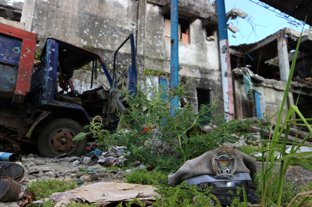 A jail police officer's cap lies among the debris and ruins of a destroyed prison in Marawi, southern Philippines. — Reuters
