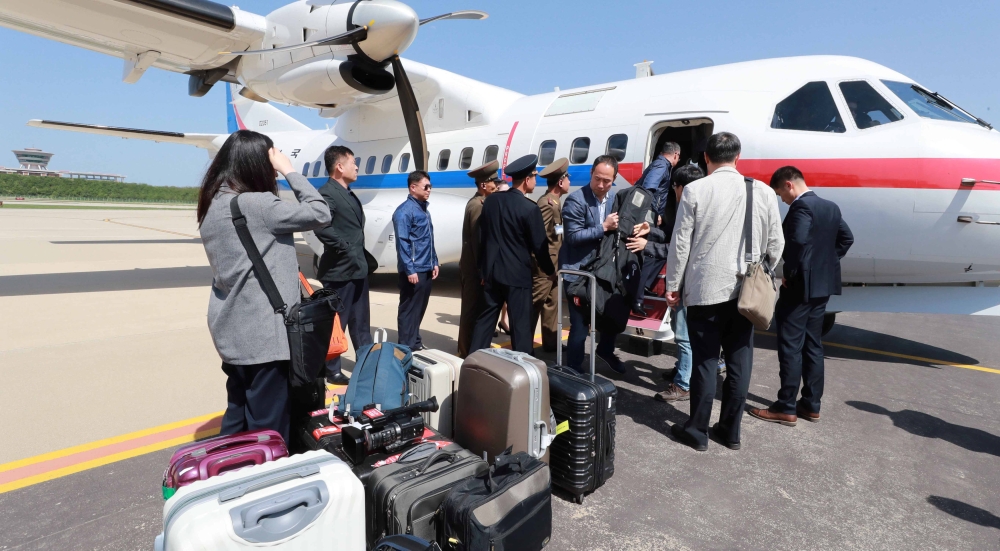 South Korean journalists, who will visit the nuclear testing site at Punggye-ri, arrive at Kalma airport in Wonsan, North Korea, Thursday.  — Reuters