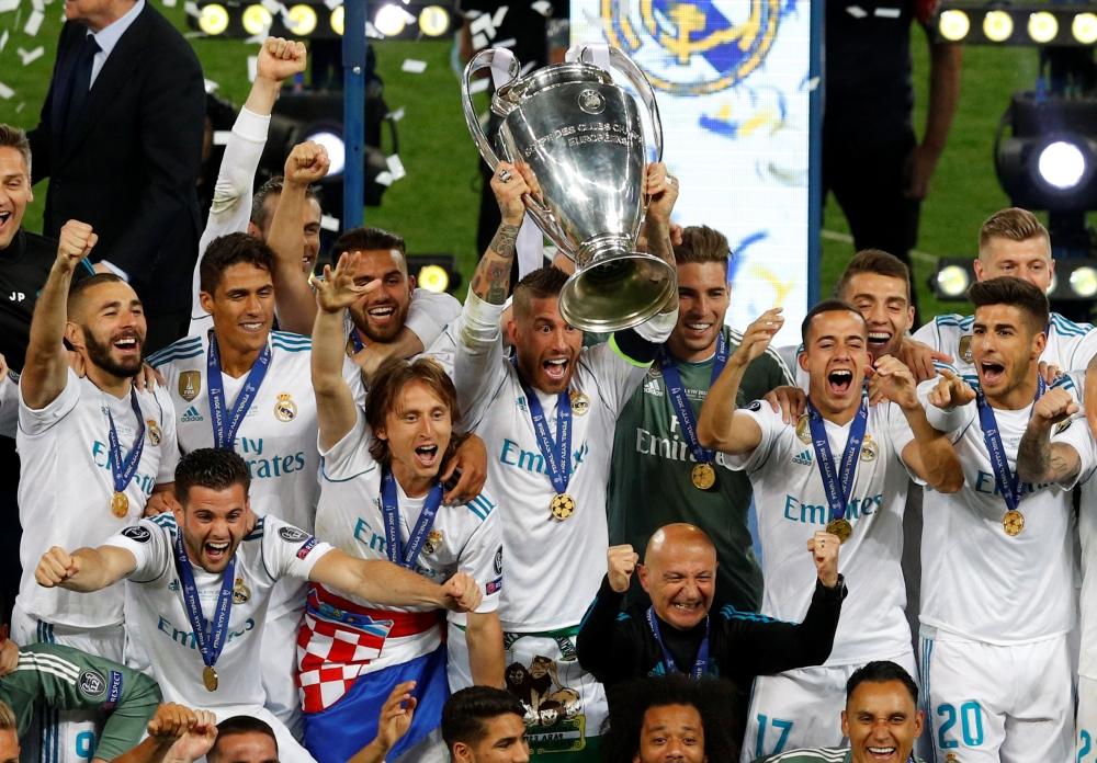 Real Madrid’s Sergio Ramos lifts the trophy as they celebrate after winning the Champions League on Saturday.  — Reuters