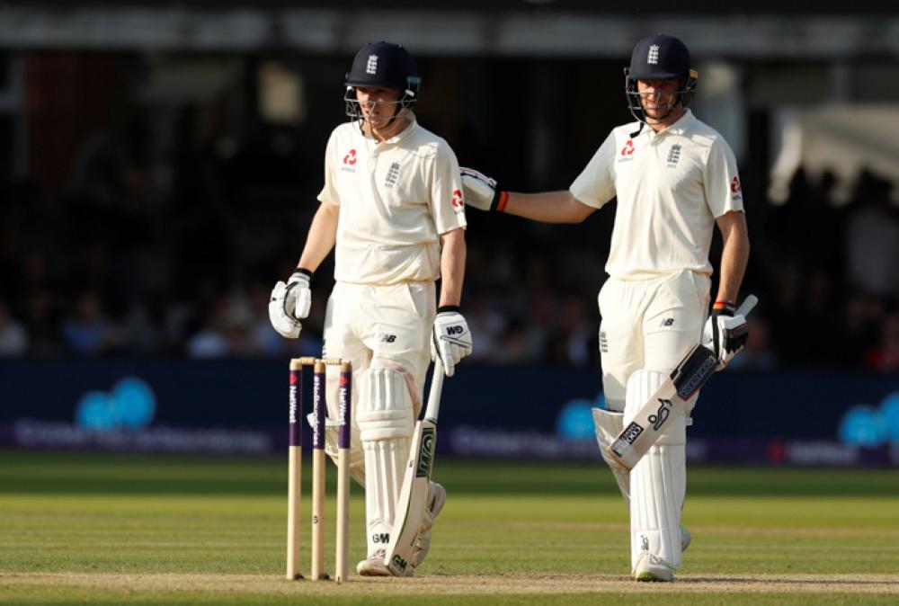 England's Dom Bess and Jos Buttler walk off the pitch at the end of play. — Reuters