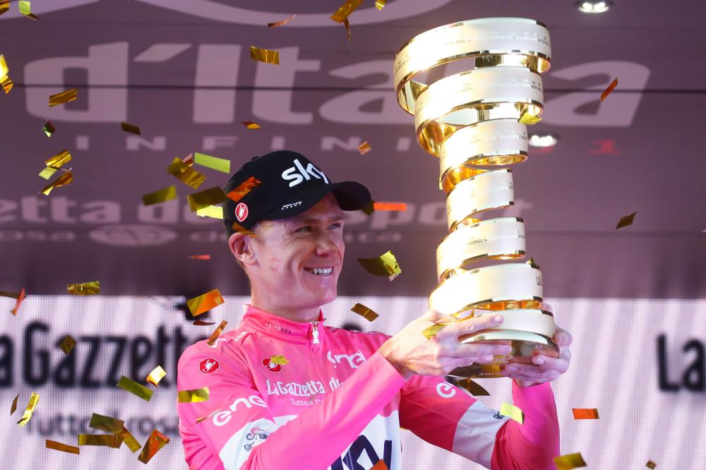 Pink jersey Britain's rider of team Sky Christopher Froome lifts the trophy on the podium after the 21st and last stage of the 101st Giro d'Italia, Tour of Italy cycling race, in Rome Sunday. — AFP