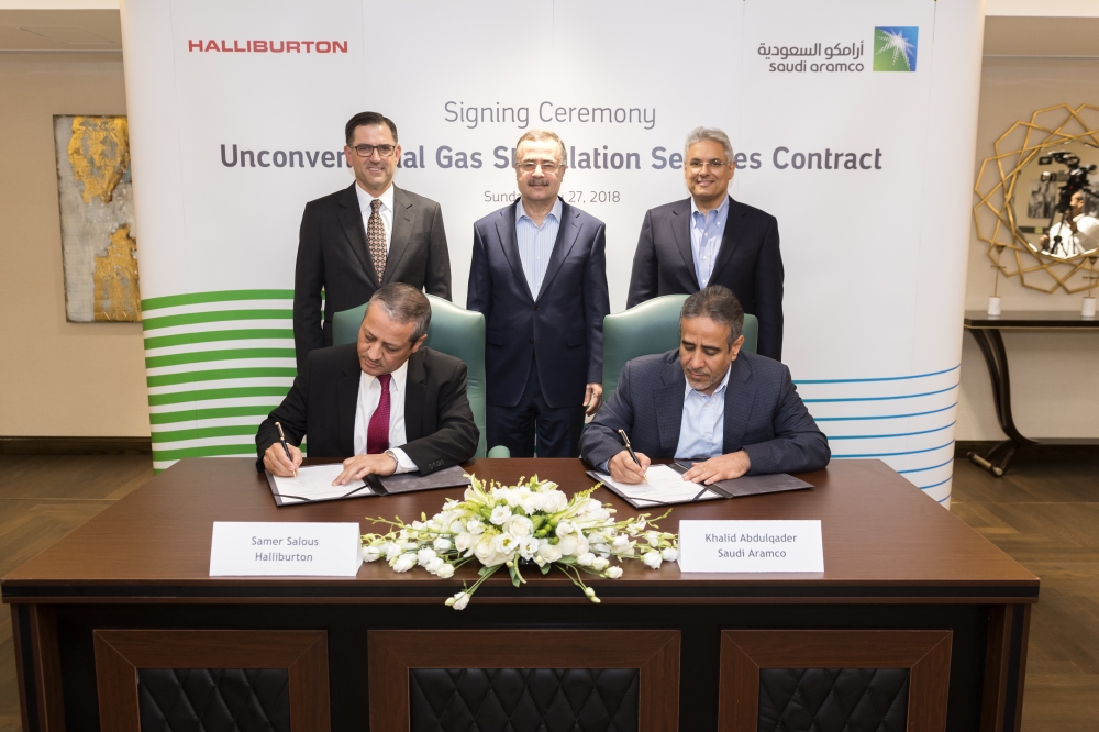 Saudi Aramco CEO Amin H. Nasser (standing center), Halliburton CEO Jeffrey A. Miller (standing, first from left)  and Saudi Aramco Sr. VP for Upstream Mohammed Y. Al Qahtani (standing, first from right), attend the signing ceremony for unconventional gas stimulation services contract on May 27, 2018 at Saudi Aramco headquarters in Dhahran, Saudi Arabia