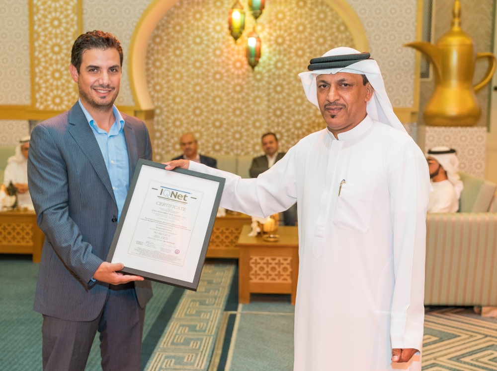 Obaid Al Salami receives the ISO certificate on behalf of Dubai Investments Real Estate Company