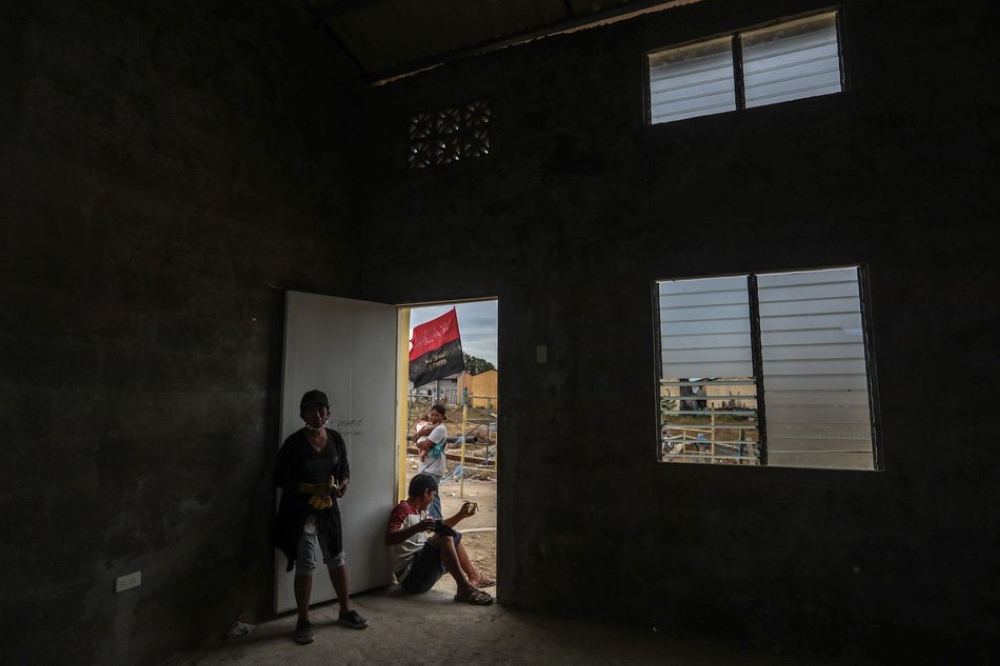 A man sits in front of the doorway of one of the idled government housing units in Pandi Bulacan to protest the inadequacy of resettlement housing for evicted squatters in Manila. — Courtesy photo