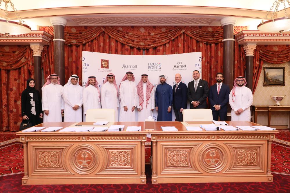 Top officials of Al Murjan Group and Marriott International pose for a group photo during the signing agreement ceremony

