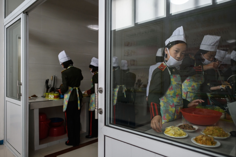 In this recent photo female students take part in cooking lessons at the Kang Pan Sok military academy in Pyongyang. Donald Trump dangled the carrot of foreign investment in front of North Korean leader Kim Jong Un at their nuclear summit, but analysts say few will want to put money into one of the highest-risk business environments in the world. — AFP